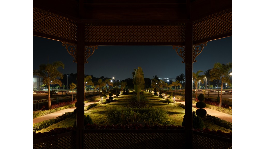36 Avenue Park viewed from gazebo framing lit lawns and paths