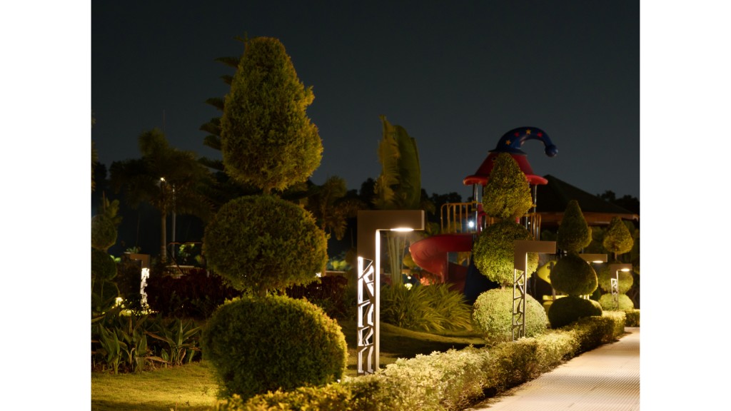 36 Avenue Park topiary, patterned path lights and playground beyond