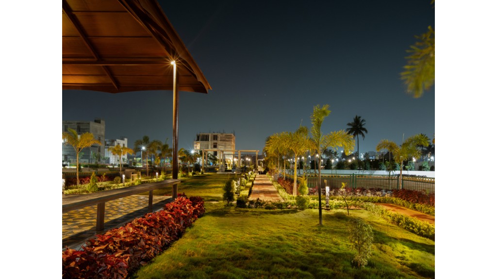 36 Avenue Park pavilion, lawn and pathway with warm landscape lighting