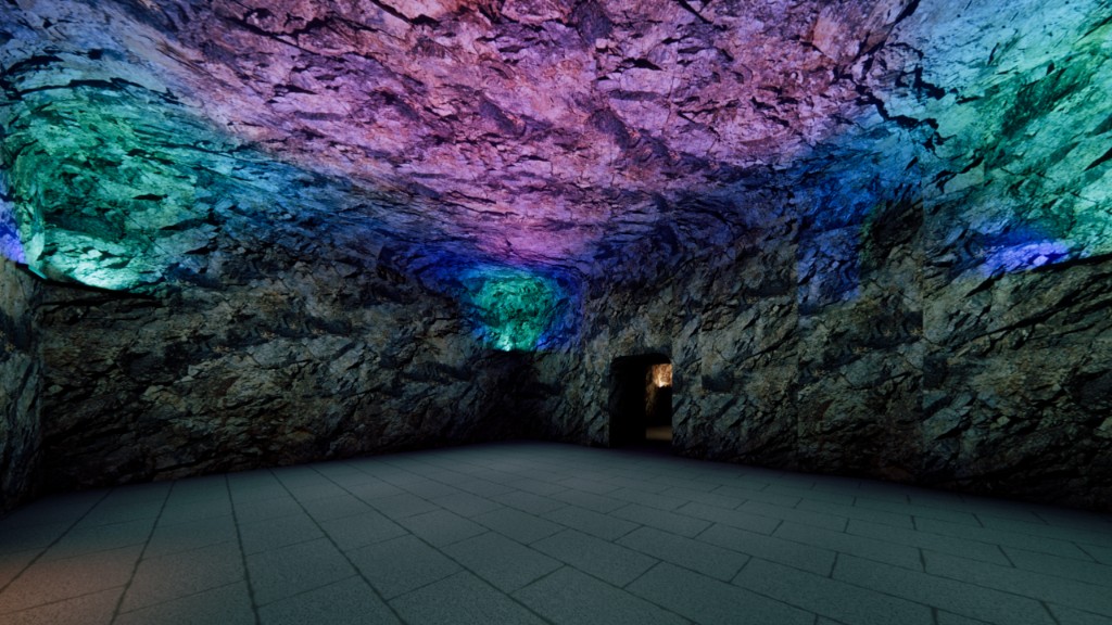 Kailashgiri cave hall with colored uplighting on rock surfaces